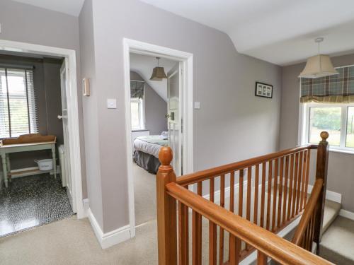 a room with a staircase and a bedroom with a bed at Heatherbrae in Barnard Castle