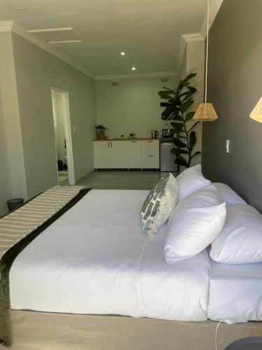a large bed with white pillows in a bedroom at 10 Paul Roos in Kimberley