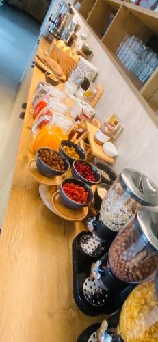 a table topped with lots of different types of food at Hotel Garni Vinea Montis in Termeno