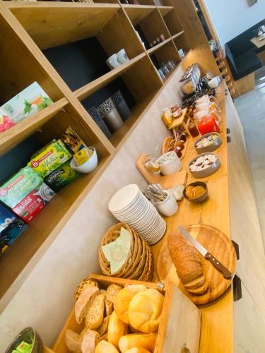 a table with bread and other foods on it at Hotel Garni Vinea Montis in Termeno
