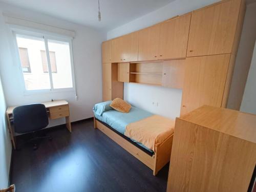 a small bedroom with a bunk bed and a desk at Fogar de Menduiña in Cangas de Morrazo