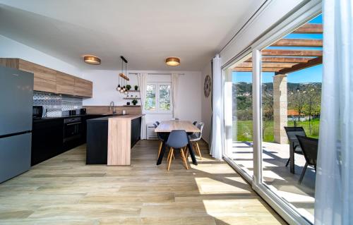 a kitchen and dining room with a table and chairs at Villa Calma in Rab