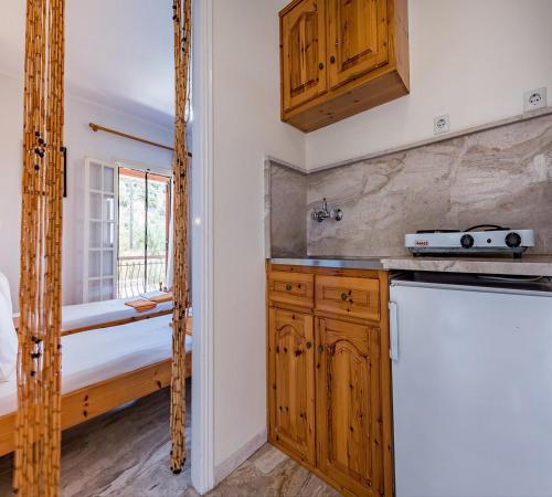 a kitchen with wooden cabinets and a sink at 8 KEYS by Katerina in Kalamaki