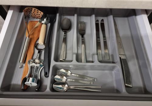 a tray with utensils in a kitchen sink at Люкс залізничний вокзал in Luts'k