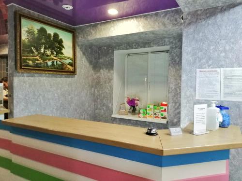 a colorful counter in a restaurant with a painting on the wall at Sweet Home in Dnipro