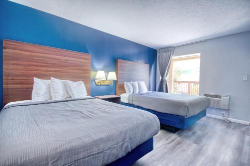 a hotel room with two beds and a window at South Seas Ocean Front in Myrtle Beach
