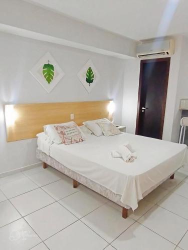 a bedroom with a large white bed in a room at Marsallis Praia JR 406 in Natal