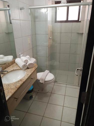 a bathroom with a shower and a sink and a toilet at Marsallis Praia JR 406 in Natal