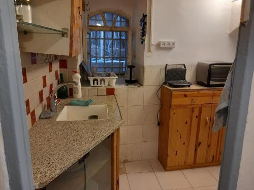 a kitchen with a sink and a counter top at גינה ירושלמית in Jerusalem