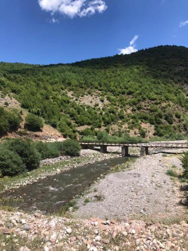 a bridge on the side of a mountain at Bujtina Gjana in Kukës