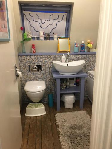 a bathroom with a sink and a toilet at Moore Crescent in Barking