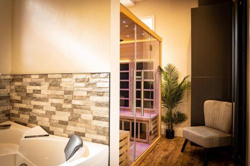 two pictures of a bathroom with a sink and a chair at Luxurious Apartment in Prestatyn in Prestatyn