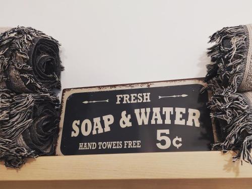 a sign that says fresh soap and water on a shelf at Koje1 in Bremm