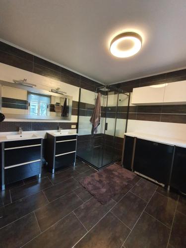 a large bathroom with two sinks and a mirror at Holiday Home Barska Vila in Bar