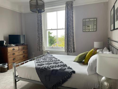a bedroom with a large bed and a window at The Royal Oak in Hawkhurst