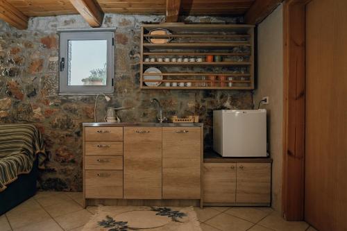 a kitchen with a sink and a window at Villa Aktis with Freshwater Pool and Sea View in Sissi