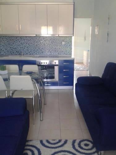 a kitchen with a couch and a table and chairs at Rudi Studios in Sarti