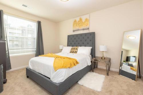 a bedroom with a bed and a large window at Elegant 2BR Suite in Downtown Waxhaw w. Pool 