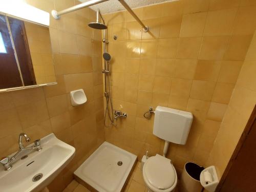 a small bathroom with a toilet and a sink at Anthy Villas department 1 in Mardhátion