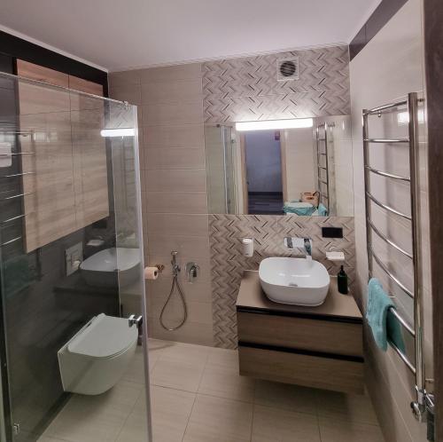 a bathroom with a sink and a shower and a toilet at Dream Town,залізничний вокзал in Lutsk