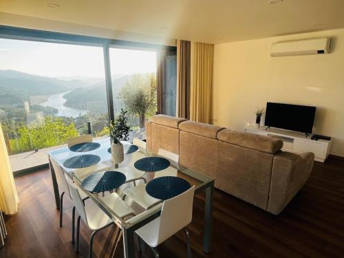 a living room with a table and a couch at Encosta do Gerês Village in Braga