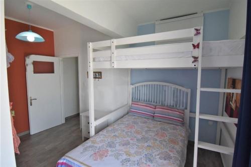 a small bedroom with two bunk beds and a bed at Eleni Penthouse Loutraki in Loutraki