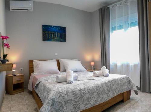 a bedroom with a bed with two towels on it at Villa Kalliope in Keramoti