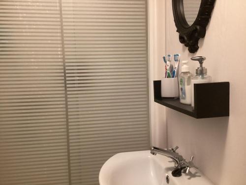 a bathroom with a shower with a toilet and a sink at Holiday Home At Seton Sands in Port Seton