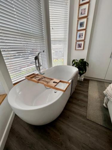 a white bath tub in a room with a window at Sandy feet retreat in Exmouth