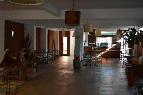 a large room with chairs and tables and a room with tables at Hotel Samka in Salta