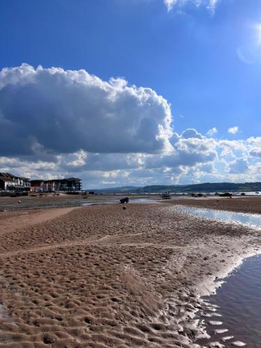 a sandy beach with footprints in the sand at Sandy feet retreat in Exmouth