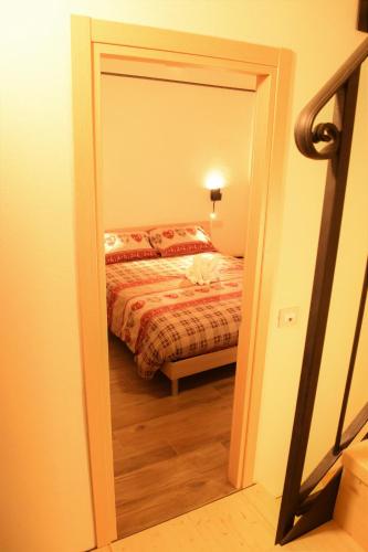 a door leading to a bedroom with a bed at B&B Da Nora in Mallare