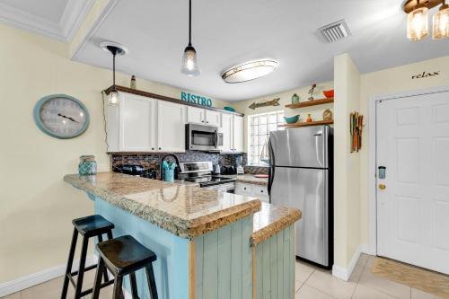 a kitchen with a counter and a refrigerator at Rain Dancer in South Padre Island