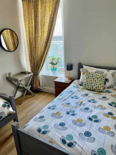 a bedroom with a bed and a window at The Blue Door in Kirkcudbright