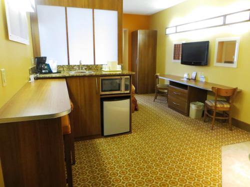 a kitchen with a sink and a counter with a microwave at Microtel by Wyndham South Bend Notre Dame University in South Bend