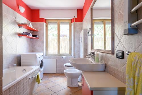 a bathroom with a white toilet and a sink at Casa Oleandri in Santa Maria Navarrese