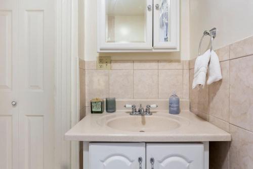 a bathroom with a sink and a mirror at The Matisse at Wooster Square Yale With Parking in New Haven