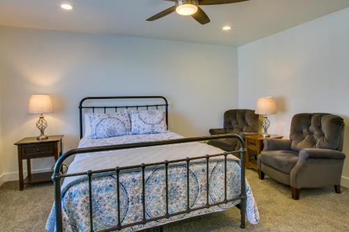 a bedroom with a bed and two chairs at 2 Mi to Zootah Providence Townhome with Fireplaces in Logan