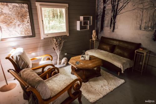 a living room with a couch and a table at Cabane insolite avec escape game in Saint-Évarzec
