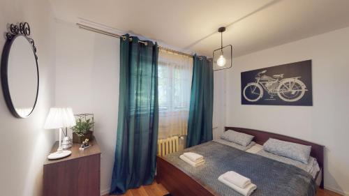 a bedroom with a bed and a bike picture on the wall at Kotlarska 7 TectumApartments in Wrocław