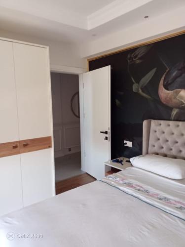 a bedroom with a bed and a painting on the wall at Dublex house - near the Airport and sea and in the city in Dalaman