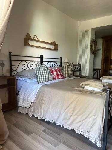 a bedroom with a large bed with pillows on it at Casa de' Trinci in Foligno