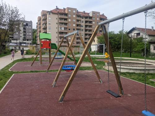 an empty swing set in a park at Banja luka Apartmans in Banja Luka