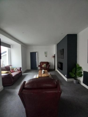 a living room with a couch and a table at NO 27 Apartment in Llandudno