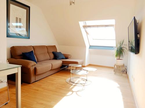 a living room with a couch and a table at Beachport in Viveiro