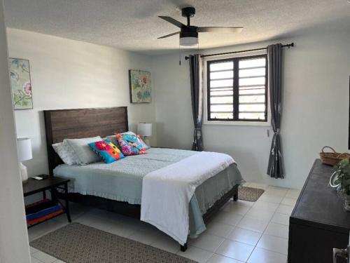 a bedroom with a bed and a ceiling fan at Sapphire Dream in St Thomas