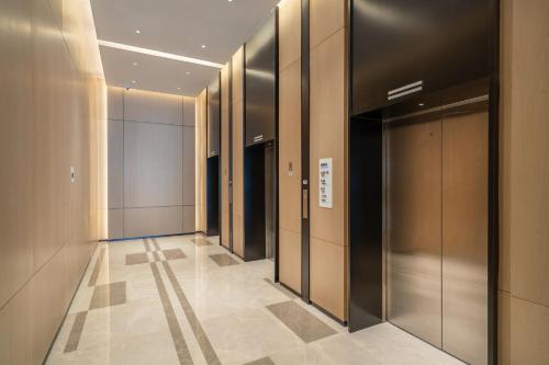 a hallway of elevators in a building at Holiday Inn Express Lanzhou New Area, an IHG Hotel in Lanzhou