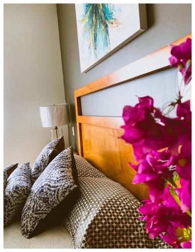 a bedroom with a bed with purple flowers on it at Terraria Apartment 5 in La Paz