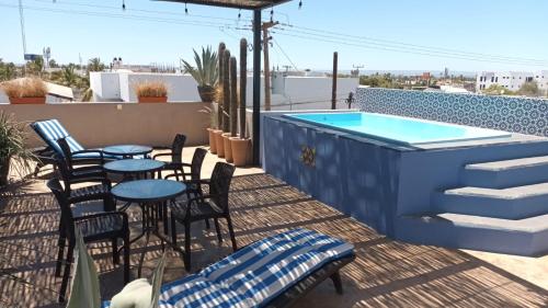 a patio with tables and chairs and a swimming pool at Terraria Apartment 5 in La Paz