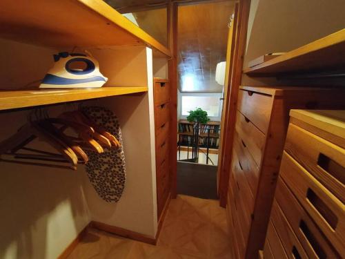 a kitchen with a closet with wooden cabinets at Il Vecchio e il Mare in Fiumicino